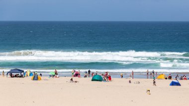 Beach blue ocean a summer holiday public relaxing destination overlooking water landscape.