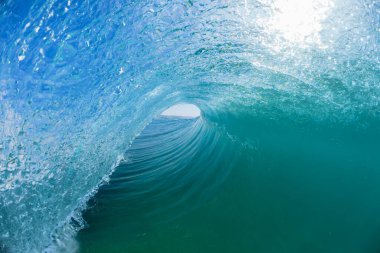Wave  ocean swimming inside hollow tubing blue water a surfer surfing ride view closeup water photography.
