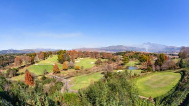 Golf course in the Drakensberg Mountains overlooking scenic holiday sporting landscape.