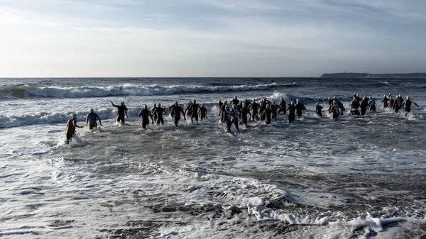 Triathlon Athletes Swim Start Beach Entering Ocean Waves Surf Swimming — Stock Photo, Image