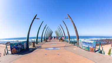 Pier Beach Jetty with elephant tusk vertical sculptures for Public walking entry blue ocean a calm warm day  a scenic holiday  landscape. clipart