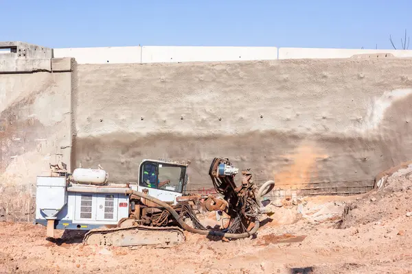 stock image Large Industrial Drilling machine vehicle for steel pylon holes to strengthen infrastructure on bridge ramp flyover expansion earthworks for engineering construction contractor .ppp