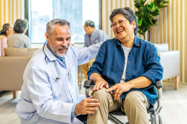 Orthopedist examines the knee of elderly patient to collect information for physical therapy treated. Doctor touch knee pain area of Old woman legs talking about knee pain symptom.