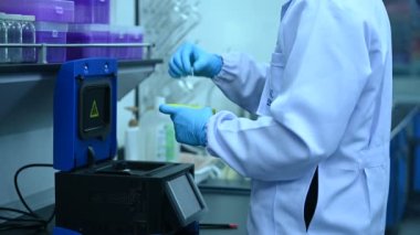 Laboratuvarda çalışan Asyalı bilim adamı, ürün deneyi yaparken, araştırmacılar deneyin sonuçlarını bulmak için analiz ettiler. Değerleri işlemek için bilimsel araçlar kullan.