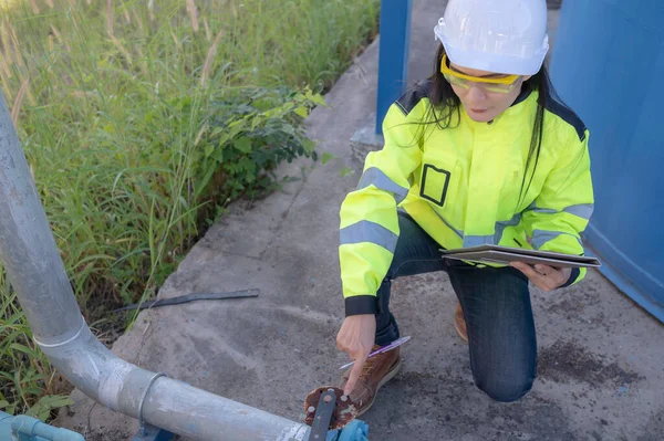 stock image Environmental engineers work at wastewater treatment plants,Female plumber technician working at water supply
