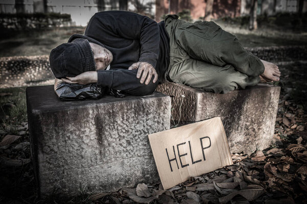 Asian man is homeless at the side road,A stranger has to live on the road alone because he has no family.