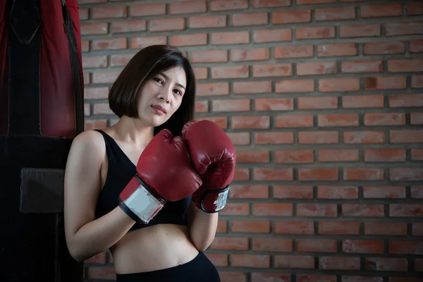 Asian beautiful woman wear glove boxing in the gym