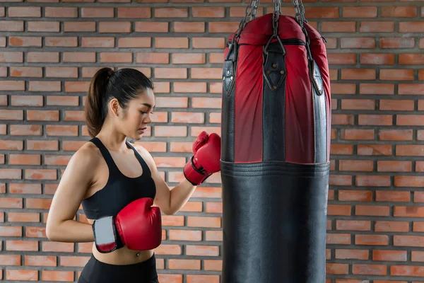 Asian sport woman wear boxing glove in the gym,Thailand people workout