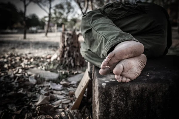 stock image Asian man is homeless at the side road,A stranger has to live on the road alone because he has no family.