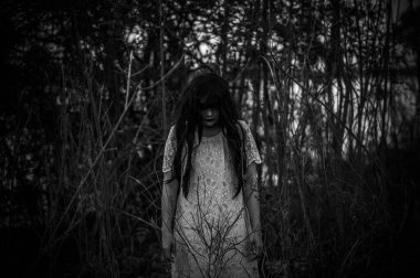 Portrait of asian woman make up ghost face at the swamp,Horror in water scene,Scary at river,Halloween poster,Thailand people