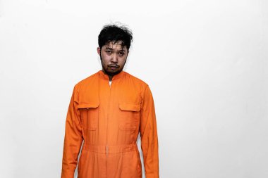 Prisoner in orange robe concept,Portrait of asian handsome man in Prison uniforms,Bandit has a lot of muscle,