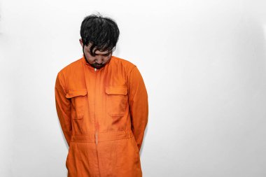 Prisoner in orange robe concept,Portrait of asian handsome man in Prison uniforms,Bandit has a lot of muscle,