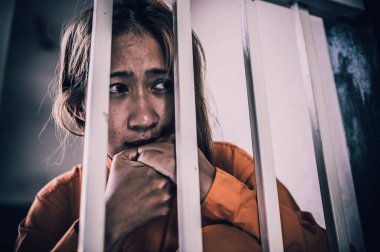 Portrait of women desperate to catch the iron prison,prisoner concept,thailand people,Hope to be free,If the violate the law would be arrested and jailed. clipart