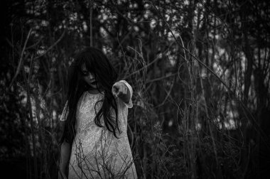 Portrait of asian woman make up ghost face at the swamp,Horror in water scene,Scary at river,Halloween poster,Thailand people
