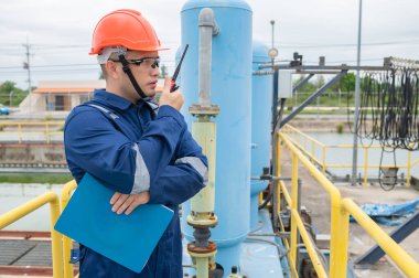 Water plant maintenance technicians, mechanical engineers check the control system at the water treatment plant. clipart