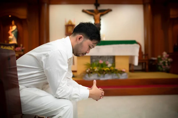 Christian man asking for blessings from God,Asian man praying to Jesus Christ