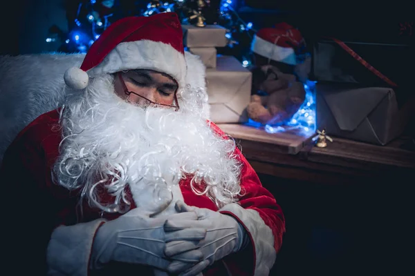Portrait of Happy santa clause reading a book,Thailand people wear santa claus dress,Sent happiness for children,Merry christmas,Welcome to winter