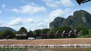 Cars riding road near river