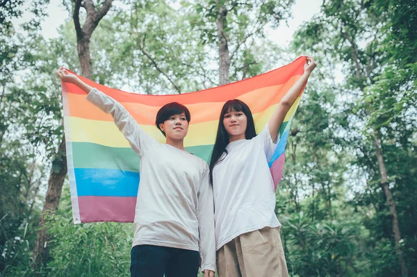 Couple of girl with girl,LGBT Pride month concept,Asian Handsome male make up and wear woman cloth,Gay Freedom Day,Portrait of Non-binary on white background