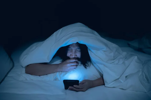 stock image Asian woman playing game on smartphone in the bed at night,Thailand people,Addict social media