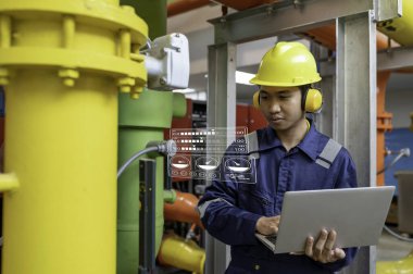 Bir ısıtma tesisinde bakım teknisyeni, Petrokimya işçileri fabrikadaki gaz ve petrol boru hatlarının işleyişini denetliyor, mühendisler işitme koruyucularını birçok boruyla aynı odaya koyuyorlar.