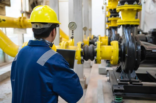 Maintenance technician at a heating plant,Petrochemical workers supervise the operation of gas and oil pipelines in the factory,Engineers put hearing protector At room with many pipes