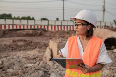 Civil engineers working at a construction site,The company manager supervises the road construction.