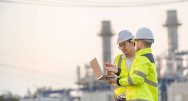 Petrol ve gaz rafinerisi fabrikasında çalışan Asyalı bir grup petrokimya mühendisi elektrik santrali enerji imalatında çalışan insan işçi mühendisi.