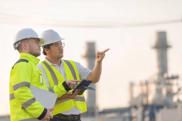 stock image Group Asian man petrochemical engineer working at oil and gas refinery plant industry factory,The people worker man engineer work control at power plant energy industry manufacturing