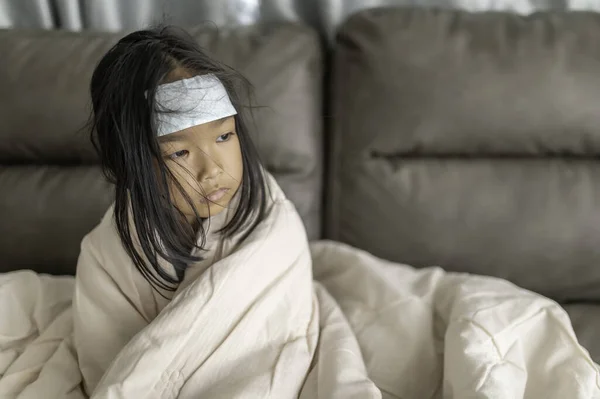 Little asian girl sick at home,Sick with the flu that came from school