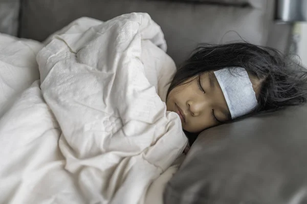 Little asian girl sick at home,Sick with the flu that came from school