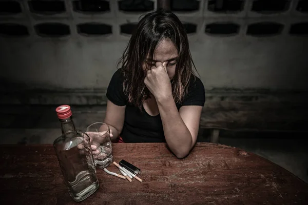 Asian woman drink vodka alone at home on night time,Thailand people,Stress woman drunk concept