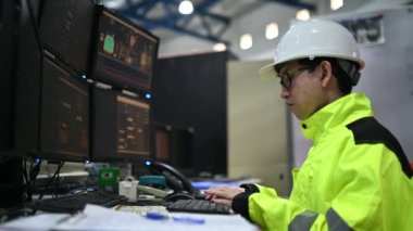 Kontrol odasında çalışan bir mühendis. Yönetici kontrol sistemi. Birçok monitörden teknisyen izleme programı