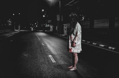 Korkunç kadın konsepti. Şehirdeki yolda bir hayalet var. Şehrin sokaklarında intikamcı bir ruh. Cadılar Bayramı festivali. Makyaj yapan hayalet surat