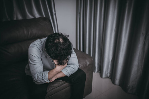 Asian handsome man stress from work overload. Tired male come back home after a lot of work from company, risk of depression