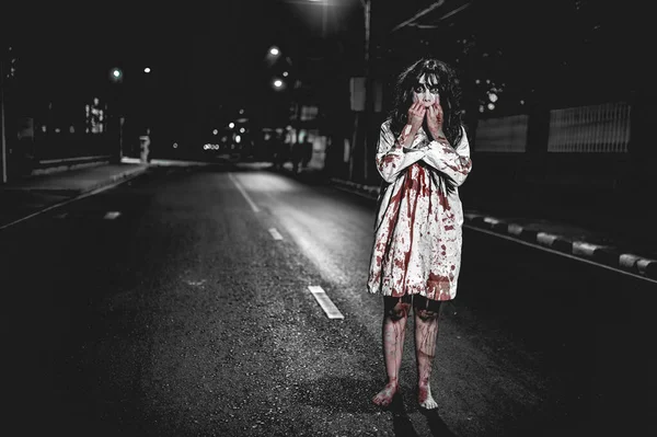 Horror woman concept. Ghost on the road in the city. A vengeful spirit on the street of the town. Halloween festival. Make up ghost face