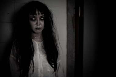 Hayaletten yapılmış Asyalı kadın portresi. Arka plan için korkunç bir korku sahnesi. Cadılar Bayramı festivali kavramı. Hayalet filmleri afişi, evde öfkeli bir ruh.