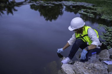 Çevre mühendisi su kalitesini inceliyor. Test için laboratuvara su getirin. Su ve topraktaki mineralleri kontrol et. Su kaynaklarındaki kirleticileri kontrol et.