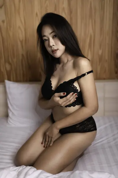 Portrait of asian sexy woman wear white dress in the bedroom