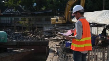 İnşaat mühendisi nehrin üzerinde köprü inşaatında çalışıyor. İnşaat mühendisi denetleme işi. Foreman bir inşaat alanında çalışıyor.
