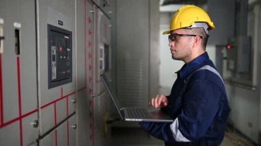 Güvenlik kaskı mühendisi ve fabrikadaki kontrol sistemi.