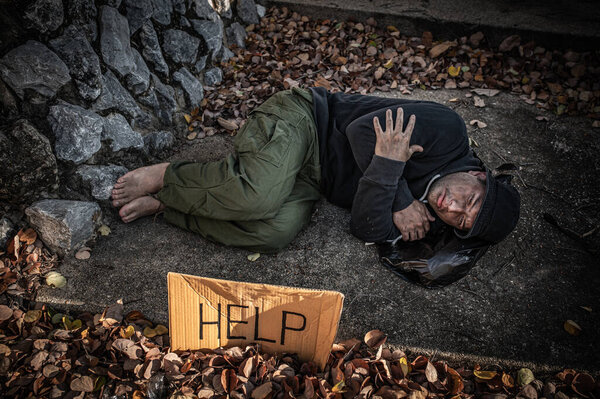 Asian man is homeless at the side road,A stranger has to live on the road alone because he has no family.