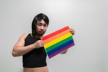 LGBT Pride month concept,Asian Handsome male make up and wear woman cloth,Gay Freedom Day,Portrait of Non-binary on white background clipart