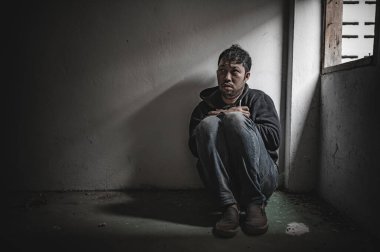 Asyalı bir bağımlı, ıssız bir yerde uyuşturucu bağımlısı, bu dünyada kendini yalnız hisseden bir keş, odanın bir köşesinde oturan üzgün bir genç, insanlar stresli ve depresyondalar.