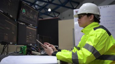 Kontrol odasında çalışan mühendis büyük sanayi tesislerinde, yönetici kontrol sisteminde, birçok monitörden teknisyen izleme programında, konsept endüstrisinde.