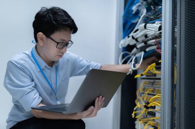 Bilgisayar mühendisi sunucu odasında ağ kuruyor, Sistem Bakım teknisyeni, erkek mühendis modern veri merkezinde sunucu odasında çalışıyor.