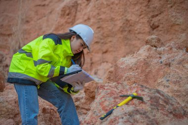 Benimkini inceleyen jeolog, kaşifler mineralleri aramak, dünyanın derinliklerini araştırmak, kaya oluşumlarını analiz etmek için toprak örnekleri topluyor.