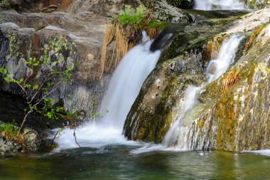waterfall of pure and crystalline water in the rivers of Las Hurdes. clipart