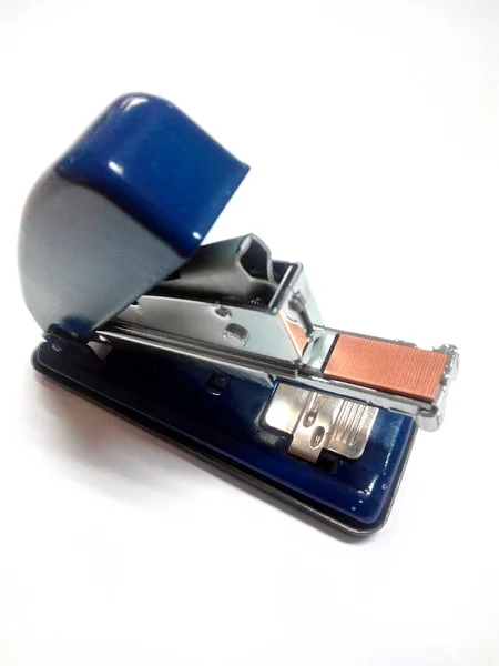 stock image blue color stapler on white table.