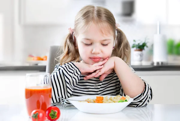Child refuses to eat,not hungry kid,doesn't like food.No appetite.Unhappy expression. Little girl does not want to eat.